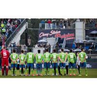 S2 players standing for the anthem before last Friday's inaugural match at Cheney Stadium