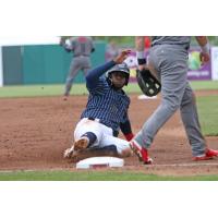 Irving Falu of the Syracuse Chiefs slides safely into third