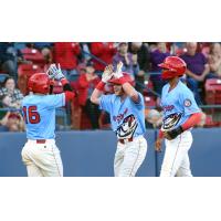 Blaine Crim of the Spokane Indians receives high fives after one of his home runs