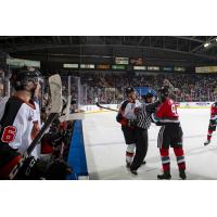 An official steps in between Mark Liwiski of the Kelowna Rockets and the Medicine Hat Tigers