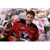 Calgary Hitmen forward Carson Focht in a pile of teddy bears