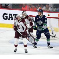 Peterborough Petes' Konnor Smith and Michael Simpson and Seattle Thunderbirds' Reid Schaefer on the ice
