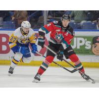 Saskatoon Blades' Zach Moore and Kelowna Rockets' Caden Price on the ice