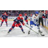 Wichita Thunder forward Jason Pineo (right) handles the puck against the Allen Americans