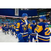 Saskatoon Blades exchange congratulations after a win