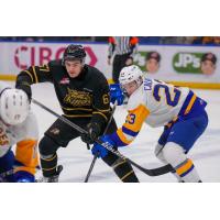 Brandon Wheat Kings' Matthew Henry and Saskatoon Blades' Rowan Calvert in action