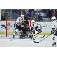 Vancouver Giants' Kyren Gronick battles Victoria Royals' Justin Kipkie and Reggie Newman