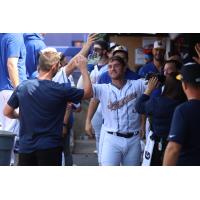 Matt O'Neill of the Syracuse Mets is congratulated in the dugout