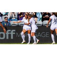 Racing Louisville forward Elexa Bahr (left) is congratulated by midfielder Jordan Baggett