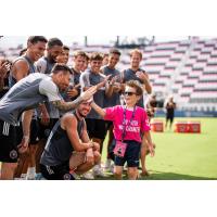 Inter Miami's Lionel Messi exchanges a high five during a Make-A-Wish experience