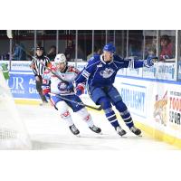 Rochester Americans' Kale Clague and Syracuse Crunch's Milo Roelens in action